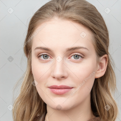 Joyful white young-adult female with long  brown hair and blue eyes