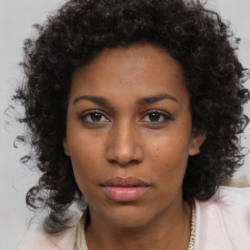 Neutral black young-adult female with medium  brown hair and brown eyes