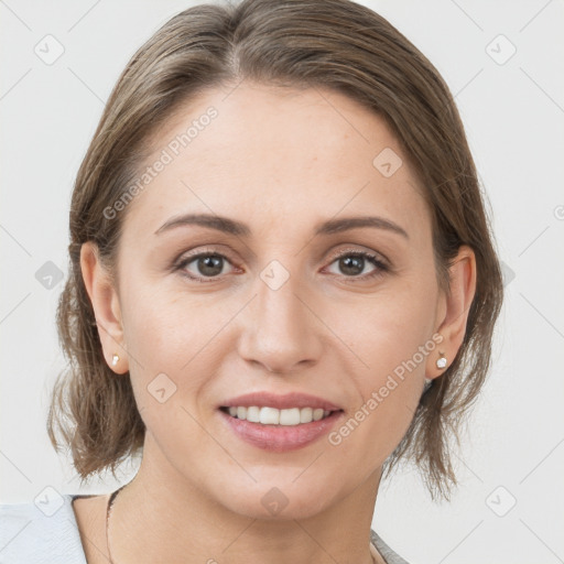 Joyful white young-adult female with medium  brown hair and grey eyes