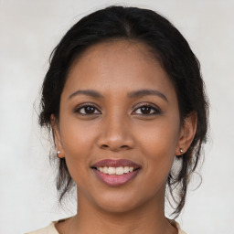 Joyful latino young-adult female with medium  brown hair and brown eyes