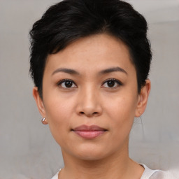 Joyful asian young-adult female with short  black hair and brown eyes