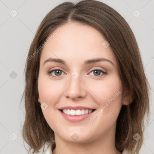 Joyful white young-adult female with medium  brown hair and green eyes