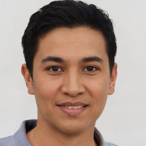 Joyful asian young-adult male with short  black hair and brown eyes