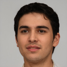 Joyful white young-adult male with short  black hair and brown eyes