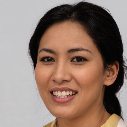Joyful asian young-adult female with medium  brown hair and brown eyes