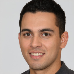 Joyful white young-adult male with short  black hair and brown eyes