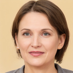 Joyful white adult female with medium  brown hair and grey eyes