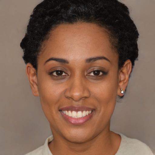 Joyful latino young-adult female with short  black hair and brown eyes