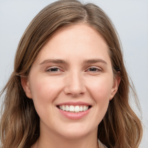 Joyful white young-adult female with long  brown hair and grey eyes