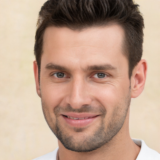 Joyful white young-adult male with short  brown hair and brown eyes