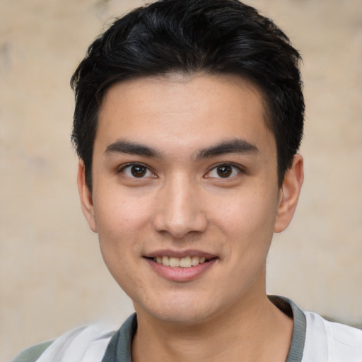 Joyful white young-adult male with short  black hair and brown eyes