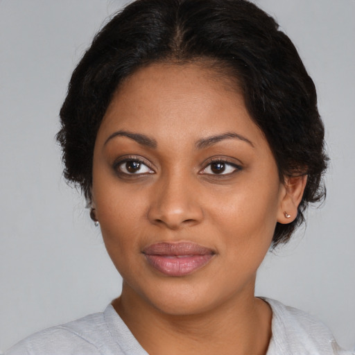 Joyful black young-adult female with medium  black hair and brown eyes