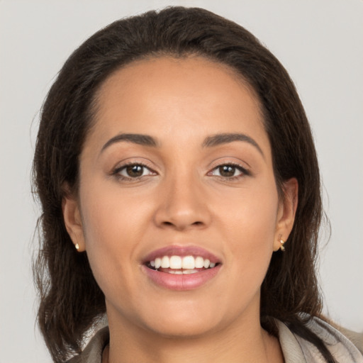 Joyful white young-adult female with long  brown hair and brown eyes