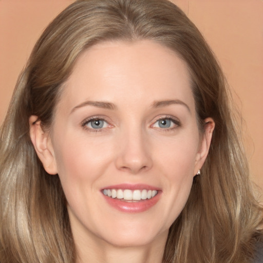 Joyful white young-adult female with long  brown hair and grey eyes