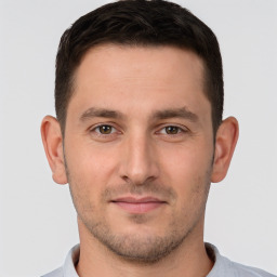 Joyful white young-adult male with short  brown hair and brown eyes