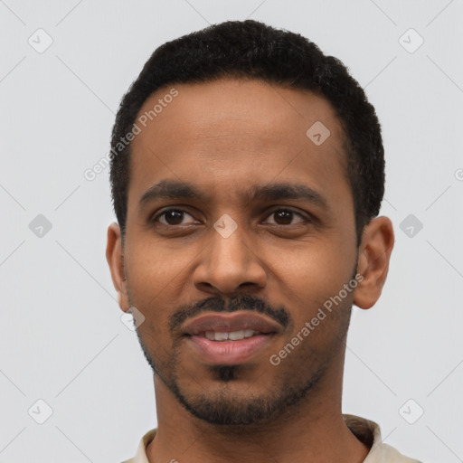 Joyful black young-adult male with short  black hair and brown eyes