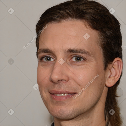 Joyful white adult male with short  brown hair and brown eyes