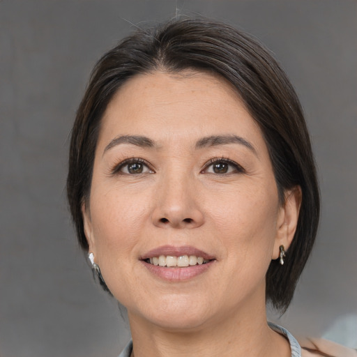 Joyful white adult female with medium  brown hair and brown eyes