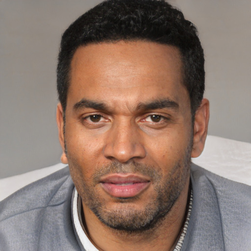 Neutral black adult male with short  black hair and brown eyes