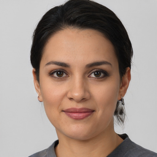 Joyful white young-adult female with medium  black hair and brown eyes