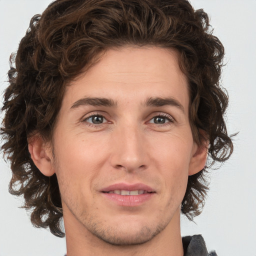 Joyful white young-adult male with medium  brown hair and brown eyes