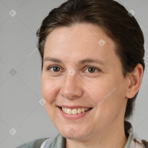 Joyful white adult female with medium  brown hair and brown eyes