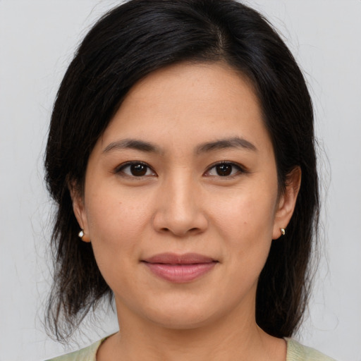 Joyful asian young-adult female with medium  brown hair and brown eyes