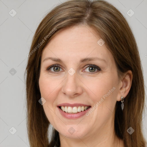 Joyful white adult female with long  brown hair and brown eyes