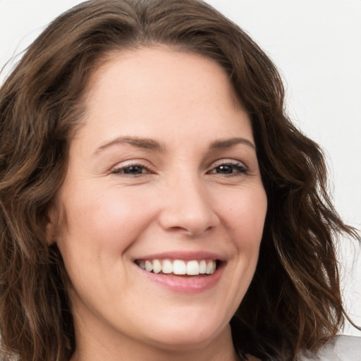 Joyful white young-adult female with long  brown hair and green eyes