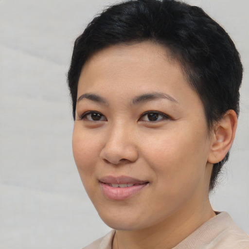 Joyful asian young-adult female with short  brown hair and brown eyes