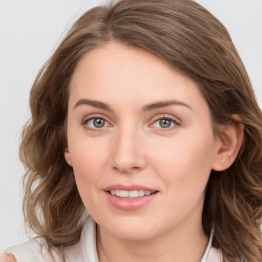 Joyful white young-adult female with medium  brown hair and blue eyes