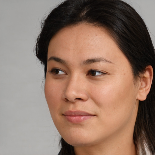 Joyful asian young-adult female with long  brown hair and brown eyes