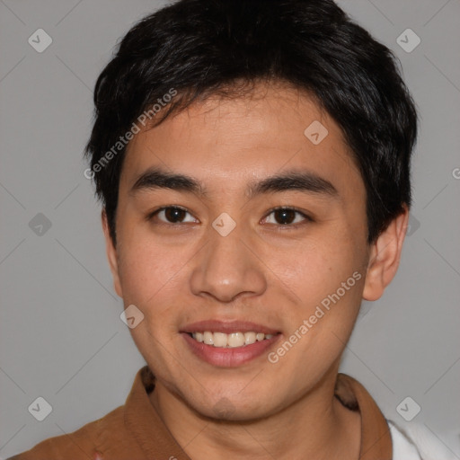 Joyful asian young-adult male with short  brown hair and brown eyes