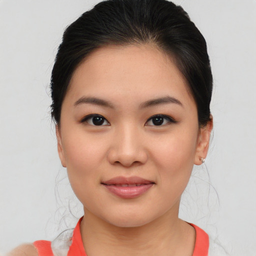 Joyful asian young-adult female with medium  brown hair and brown eyes