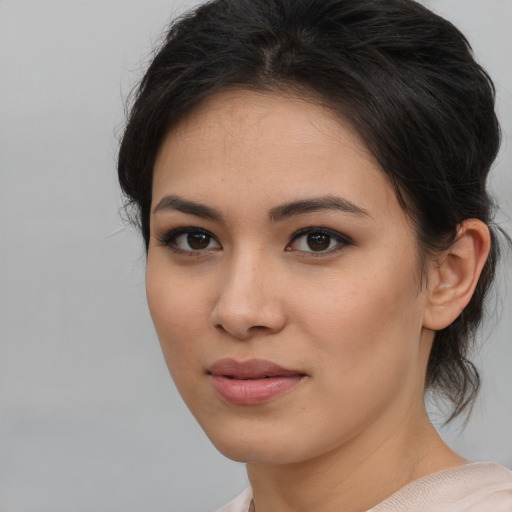 Joyful latino young-adult female with medium  brown hair and brown eyes