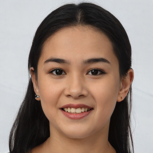 Joyful latino young-adult female with long  brown hair and brown eyes