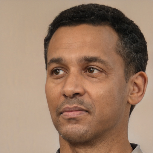 Neutral latino adult male with short  black hair and brown eyes