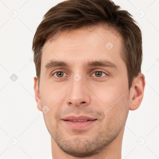 Joyful white young-adult male with short  brown hair and brown eyes