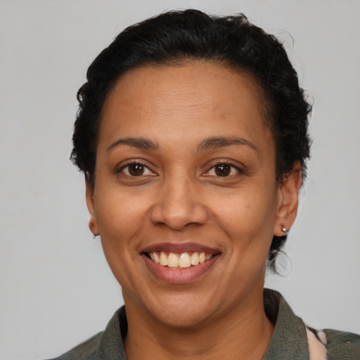 Joyful latino adult female with short  black hair and brown eyes