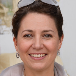 Joyful white adult female with short  brown hair and brown eyes