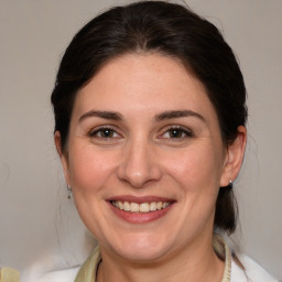 Joyful white adult female with medium  brown hair and brown eyes