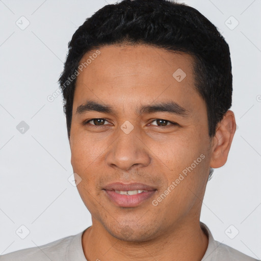 Joyful latino young-adult male with short  black hair and brown eyes