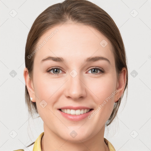 Joyful white young-adult female with medium  brown hair and grey eyes