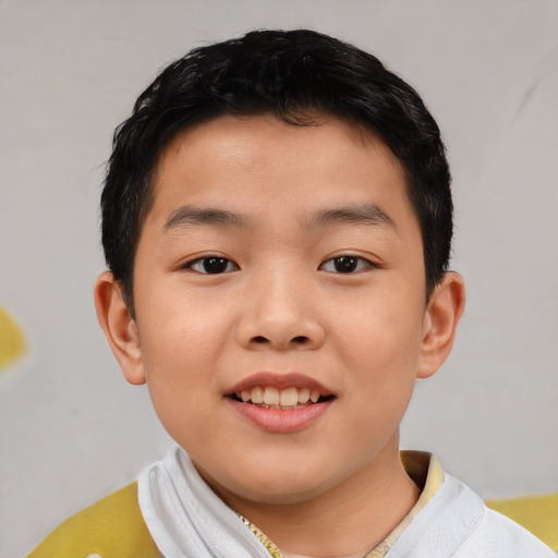 Joyful asian child male with short  brown hair and brown eyes