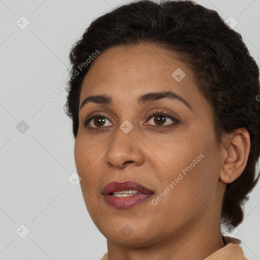 Joyful black young-adult female with short  brown hair and brown eyes