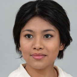 Joyful asian young-adult female with medium  black hair and brown eyes