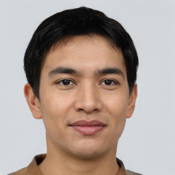 Joyful asian young-adult male with short  black hair and brown eyes