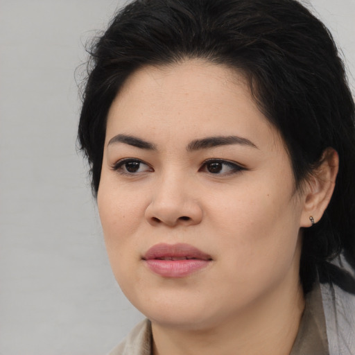 Joyful asian young-adult female with medium  black hair and brown eyes
