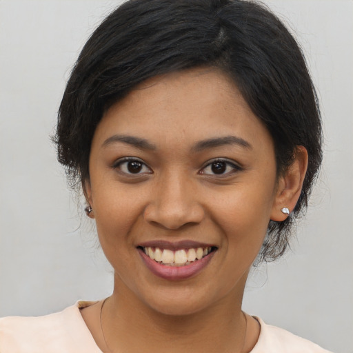 Joyful latino young-adult female with medium  black hair and brown eyes