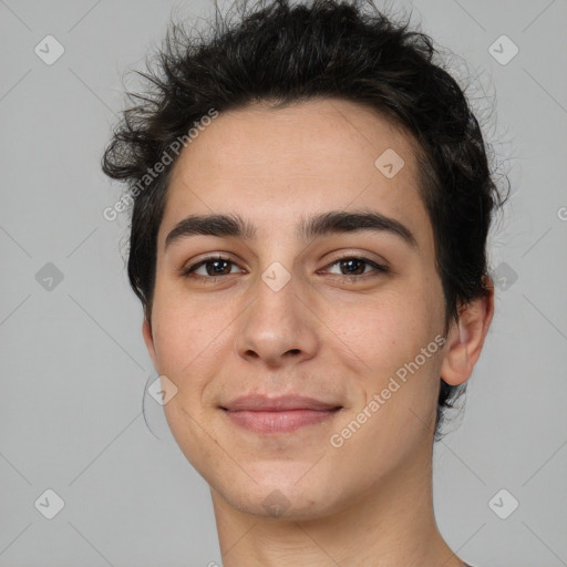 Joyful white young-adult male with short  black hair and brown eyes